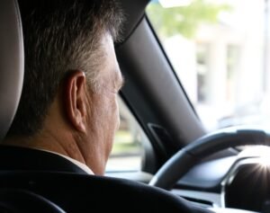 man in black shirt driving car